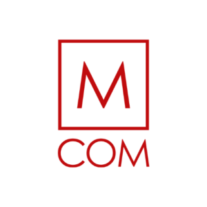 M COM